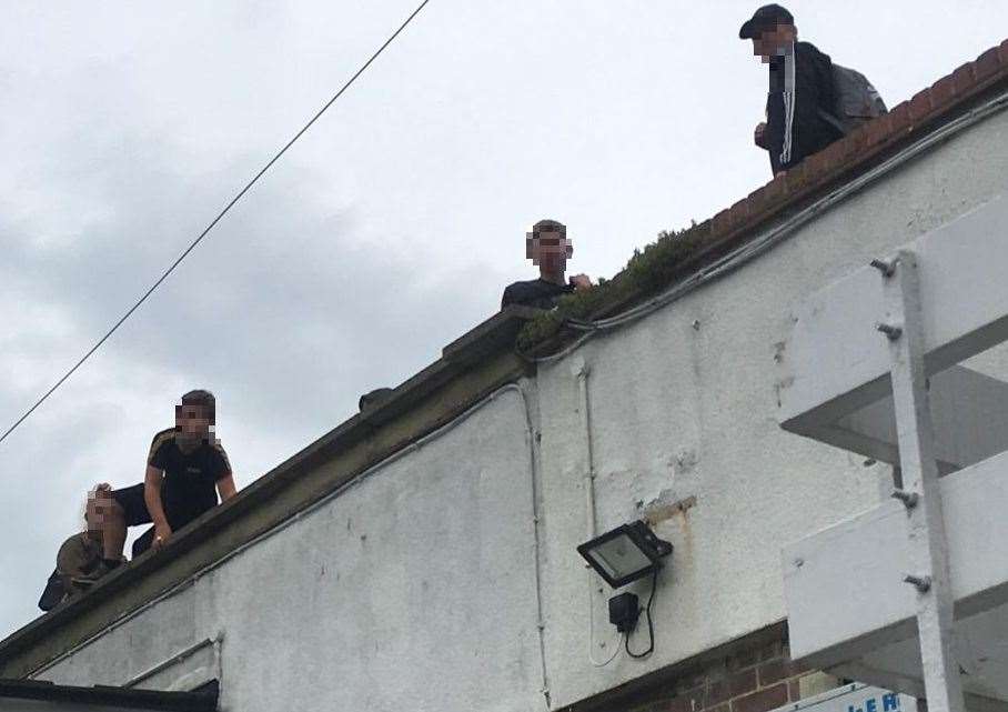 Three boys and a girl on a rooftop