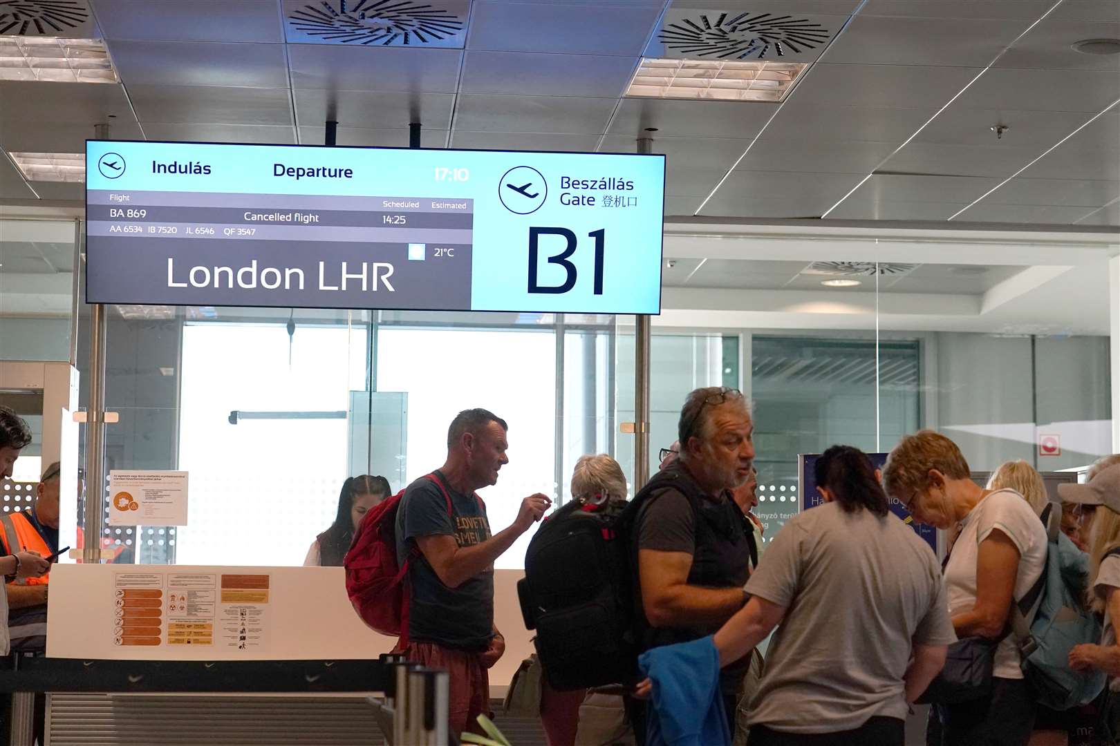 Passengers wait at a departure gate at Ferenc Liszt International Airport in Budapest, Hungary, after flights to the UK and Ireland were cancelled (Martin Rickett/PA)