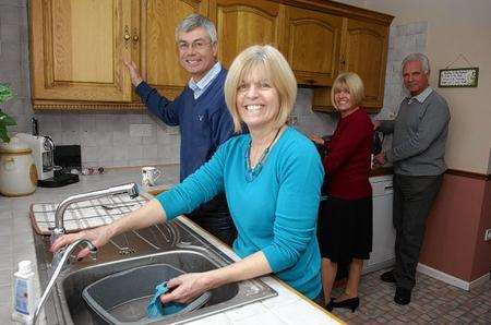 From left, Chas and Diane Howell, Jo and Graham Hatfield. Twins Jo Hatfield and Diane Howell have lived together in the same house with their respective husbands and children since 1989.