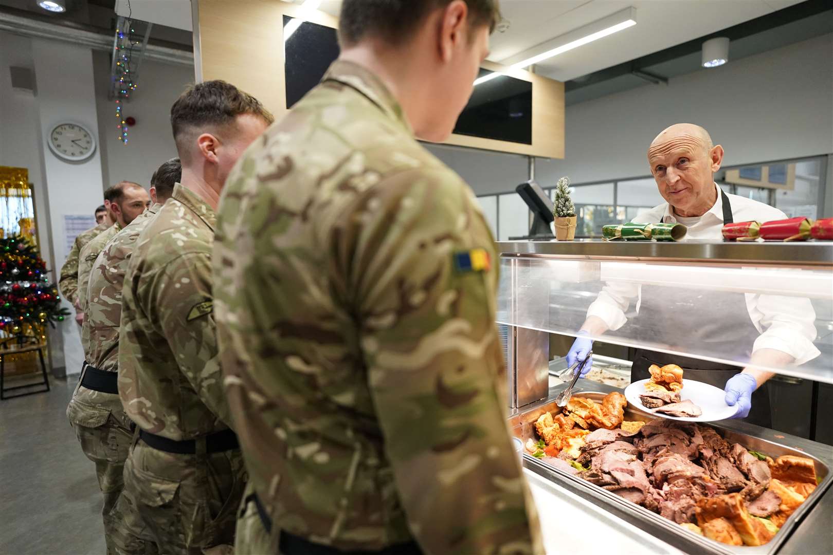 Defence Secretary John Healey serving Christmas lunch to British personnel during his visit to the Tapa military base in Estonia (Stefan Rousseau/PA)