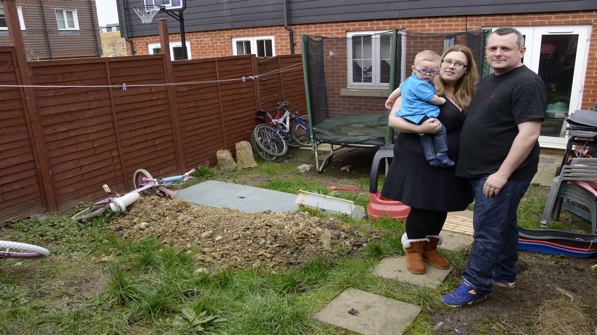 Carley and Darren McDougal with son Danny in their garden