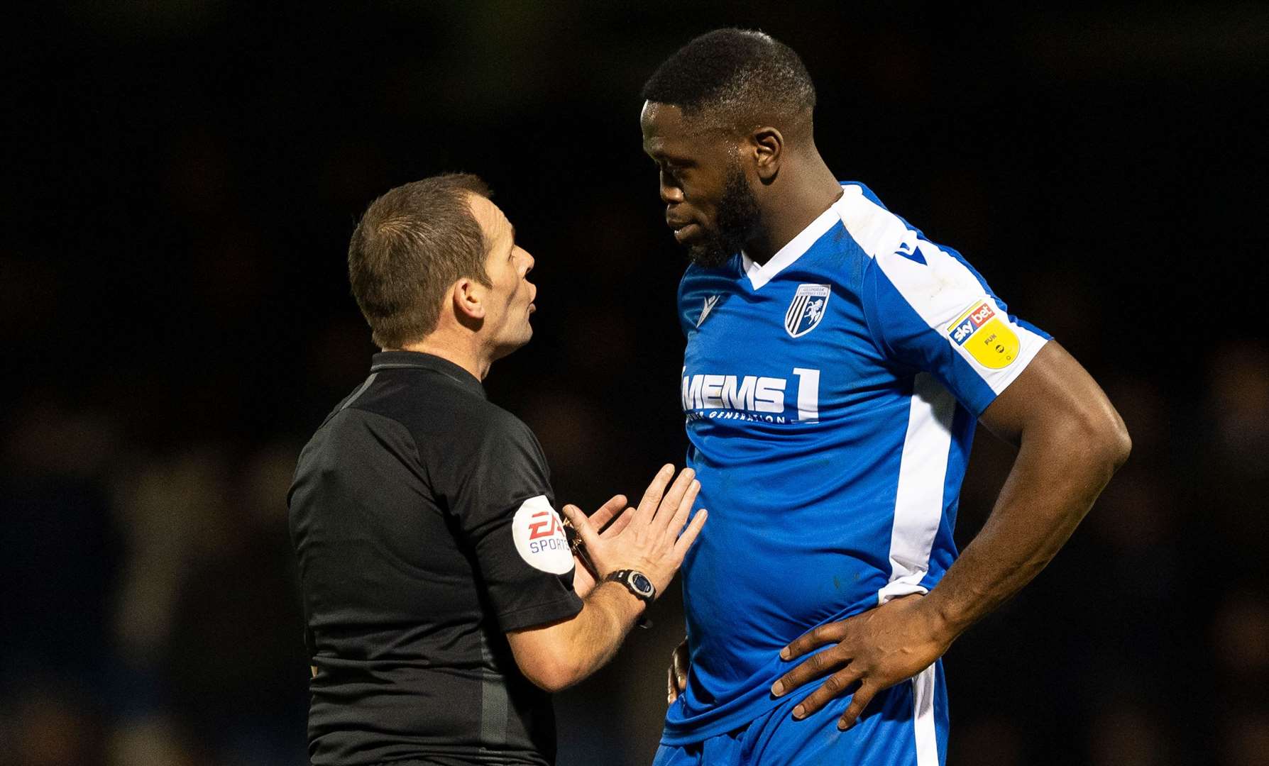 Referee Geoff Eltringham makes his point to Gills forward John Akinde against Shrewsbury. Picture: Ady Kerry