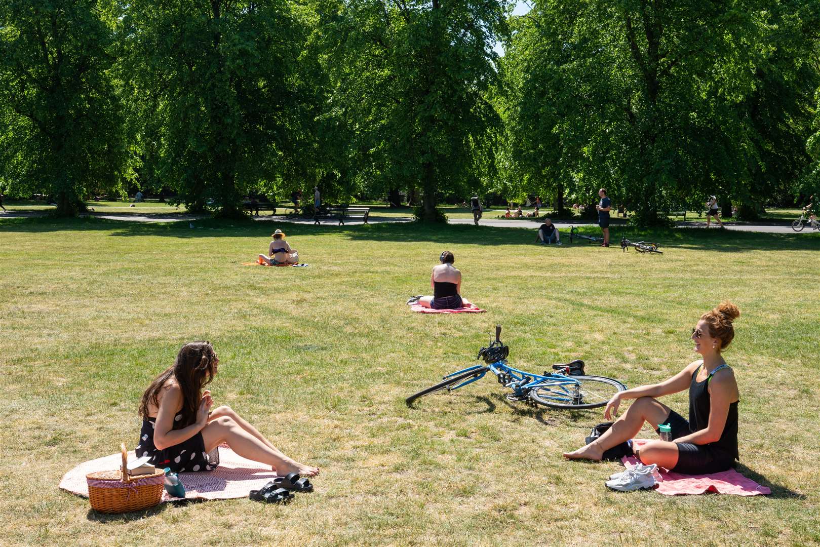 Two women observe social distancing in Greenwich Park, London (Dominic Lipinski/PA)
