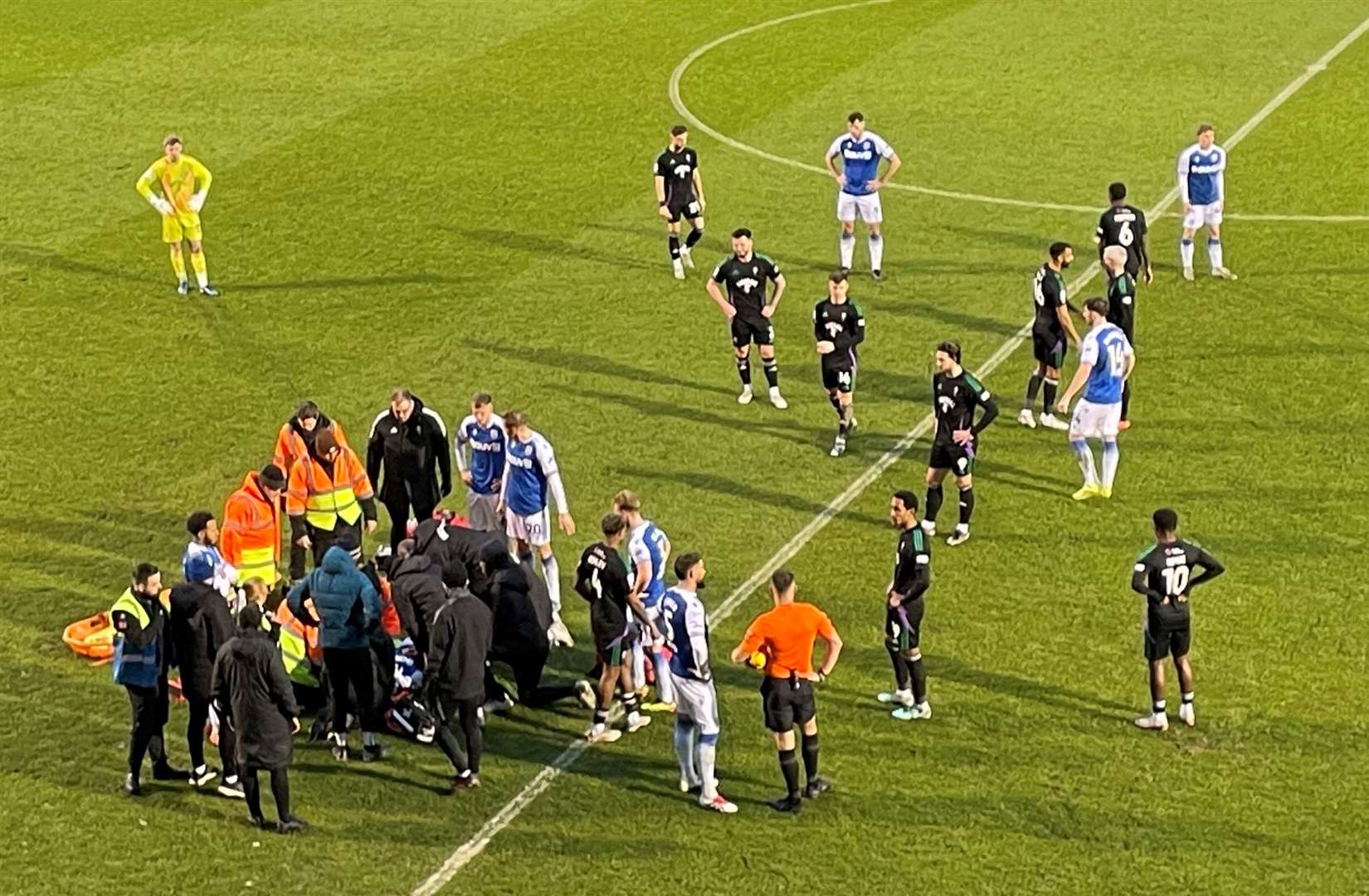 Gillingham striker Joe Gbode receives lengthy treatment on the pitch after being knocked out