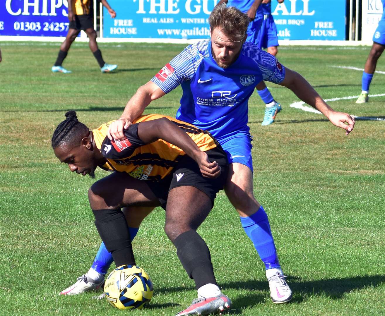 Ira Jackson Jr under pressure for Folkestone against Herne Bay's Jack Parter. Picture: Randolph File