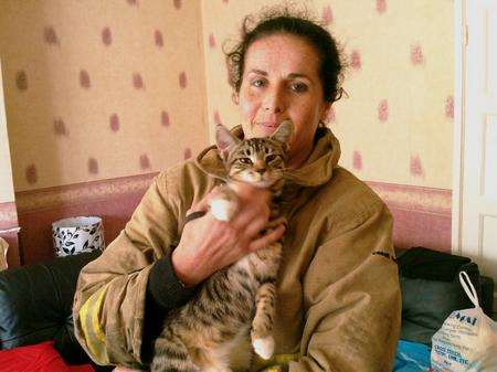 Sonic the cat with firefighter Kerry Mitchell