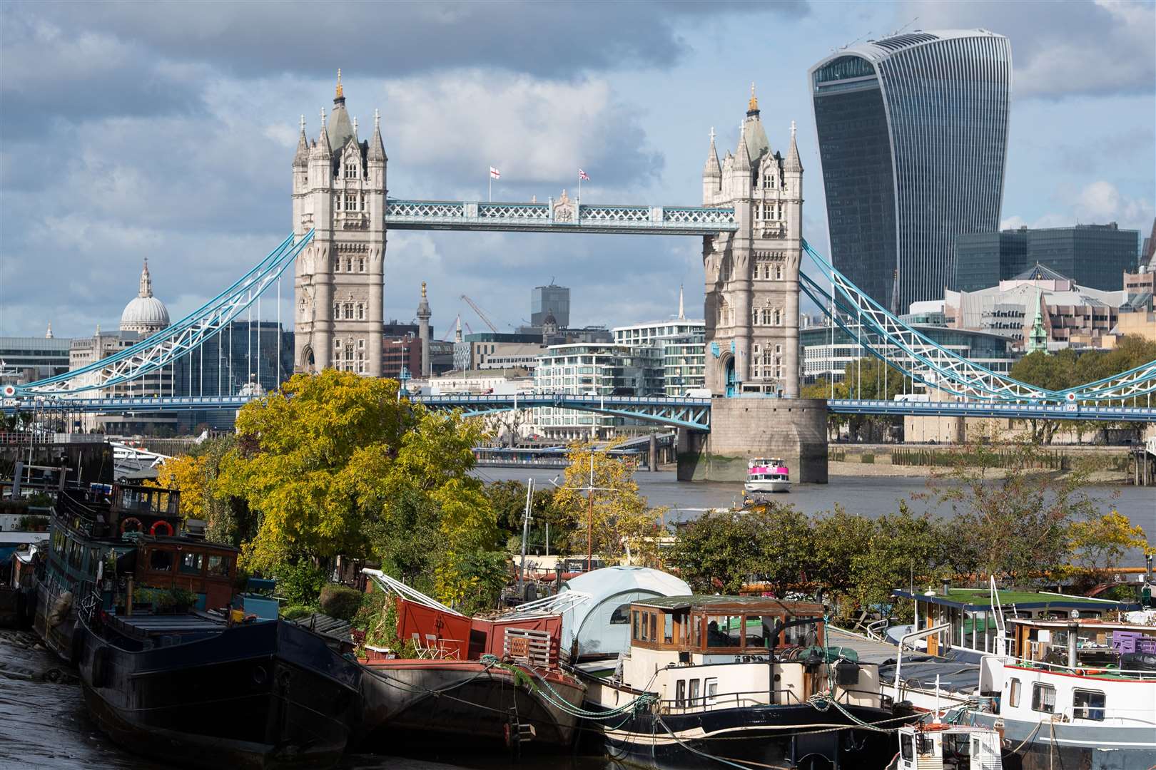 Trees displaying autumnal colours alongside Tower Bridge and the Walkie Talkie building in central London (Dominic Lipinski/PA)