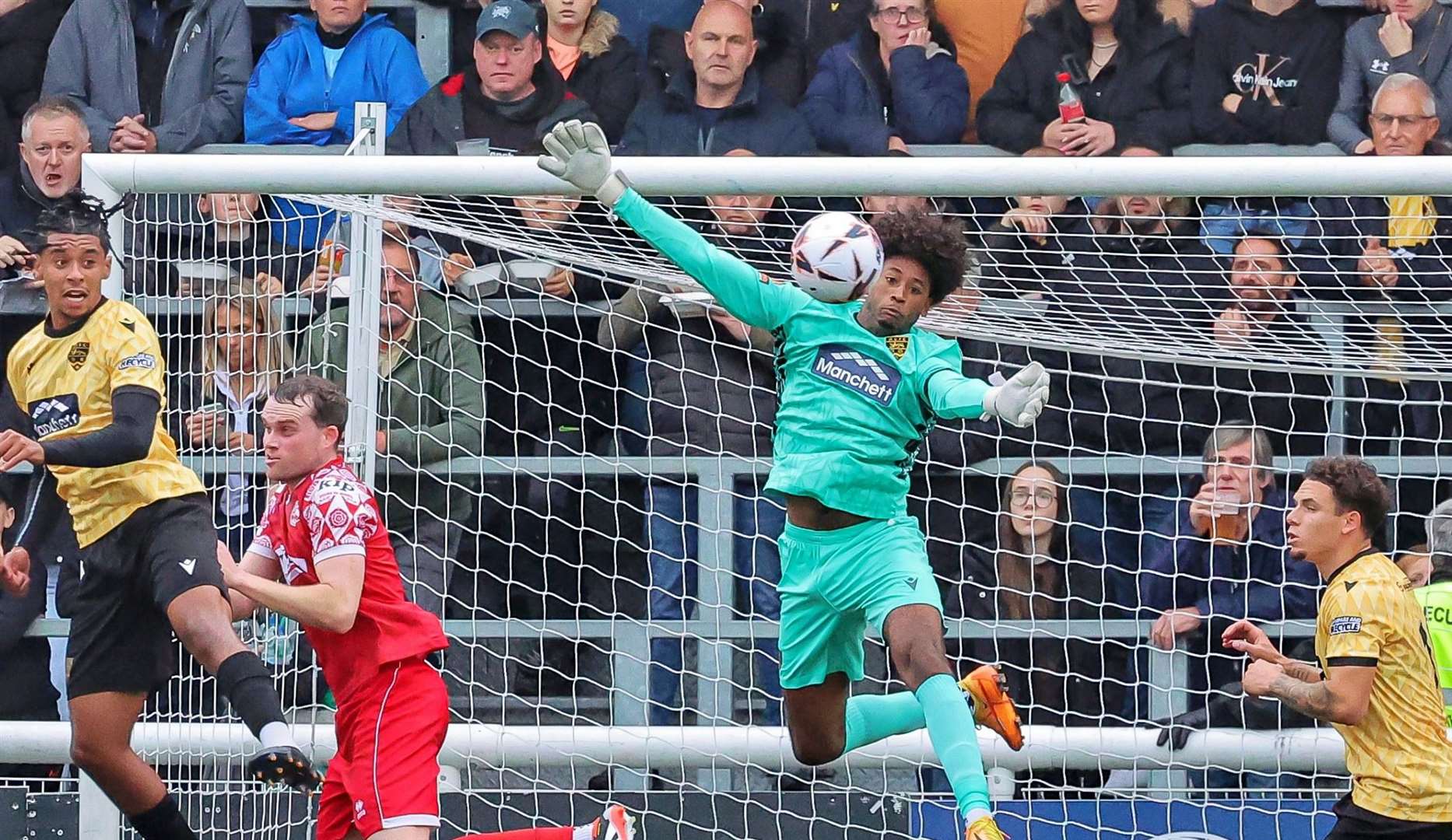 Maidstone United goalkeeper Alexis Andre Jr in the thick of it on his way to a clean sheet. Picture: Helen Cooper