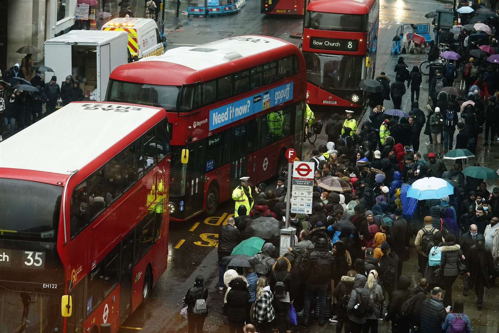 People wait to get on buses at Liverpool Street station in central London on Tuesday (Aaron Chown/PA