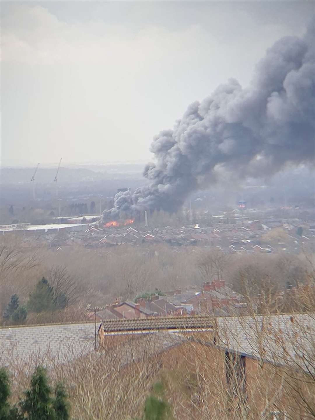 A plume of smoke earlier rising from the warehouse fire in Holland Street, Denton, Manchester (@Miraaaaa87/PA)