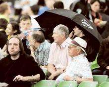 The umbrellas come out as the rain starts to fall