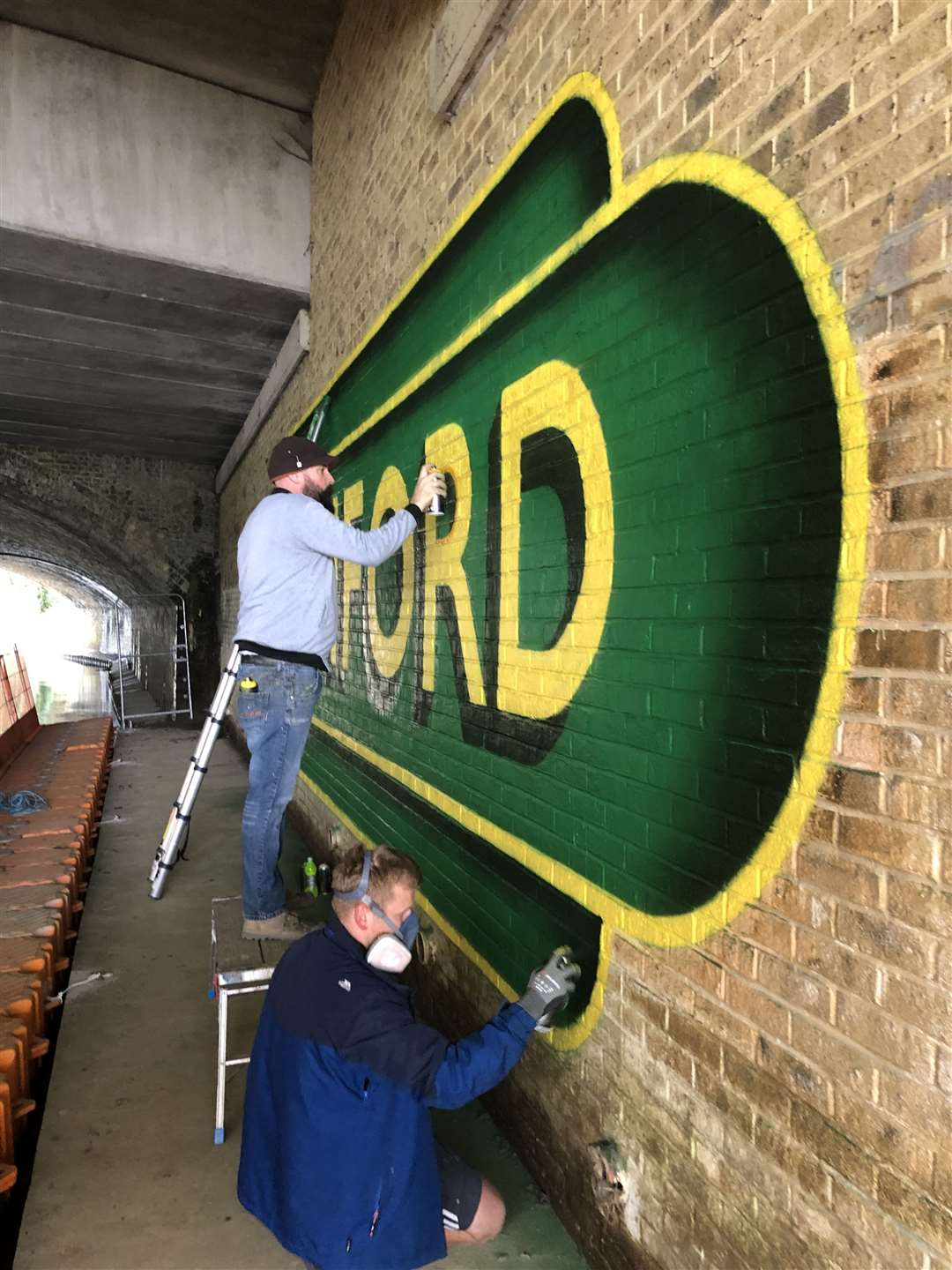 Lionel Stanhope painting the first mural on the passageway. Picture: Network Rail