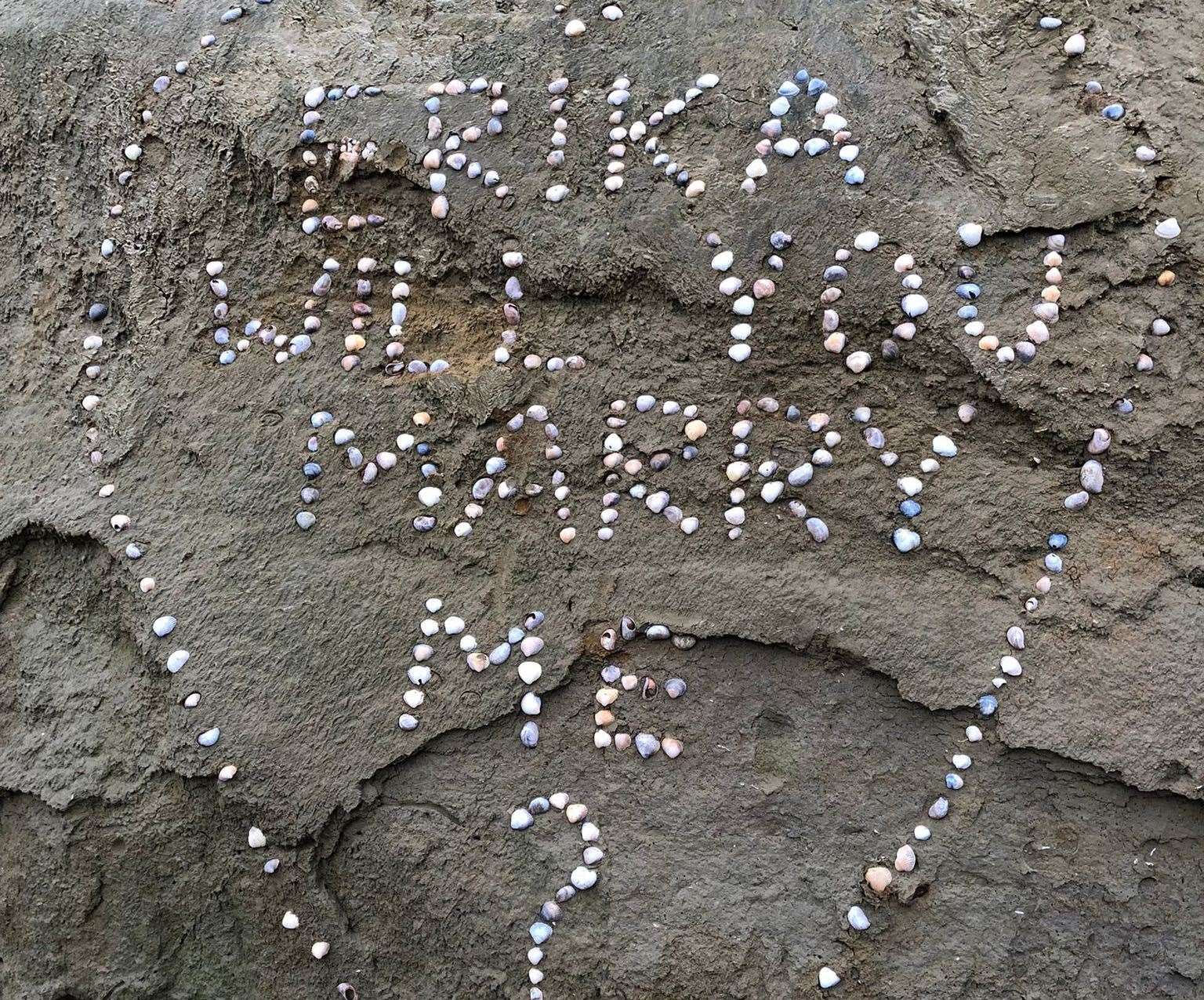 A passerby spotted the proposal still in the sand