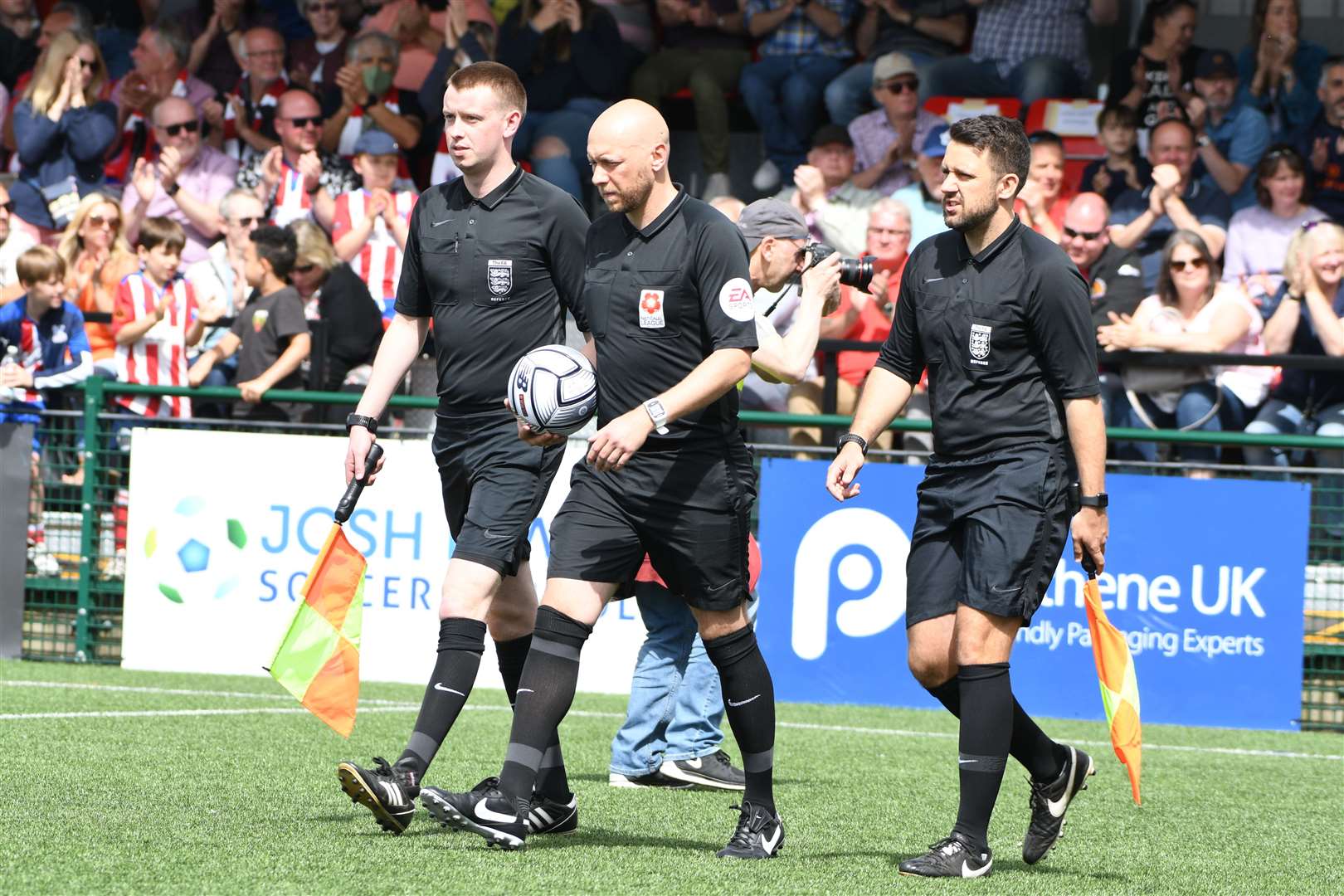 Referee Jason Richardson and his assistants lead the times out for the play-off final at Dorking. Picture: Barry Goodwin