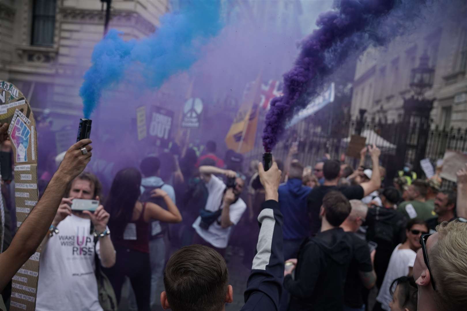 Protesters let off flares outside Downing Street during the anti-lockdown march (Aaron Chown/PA)