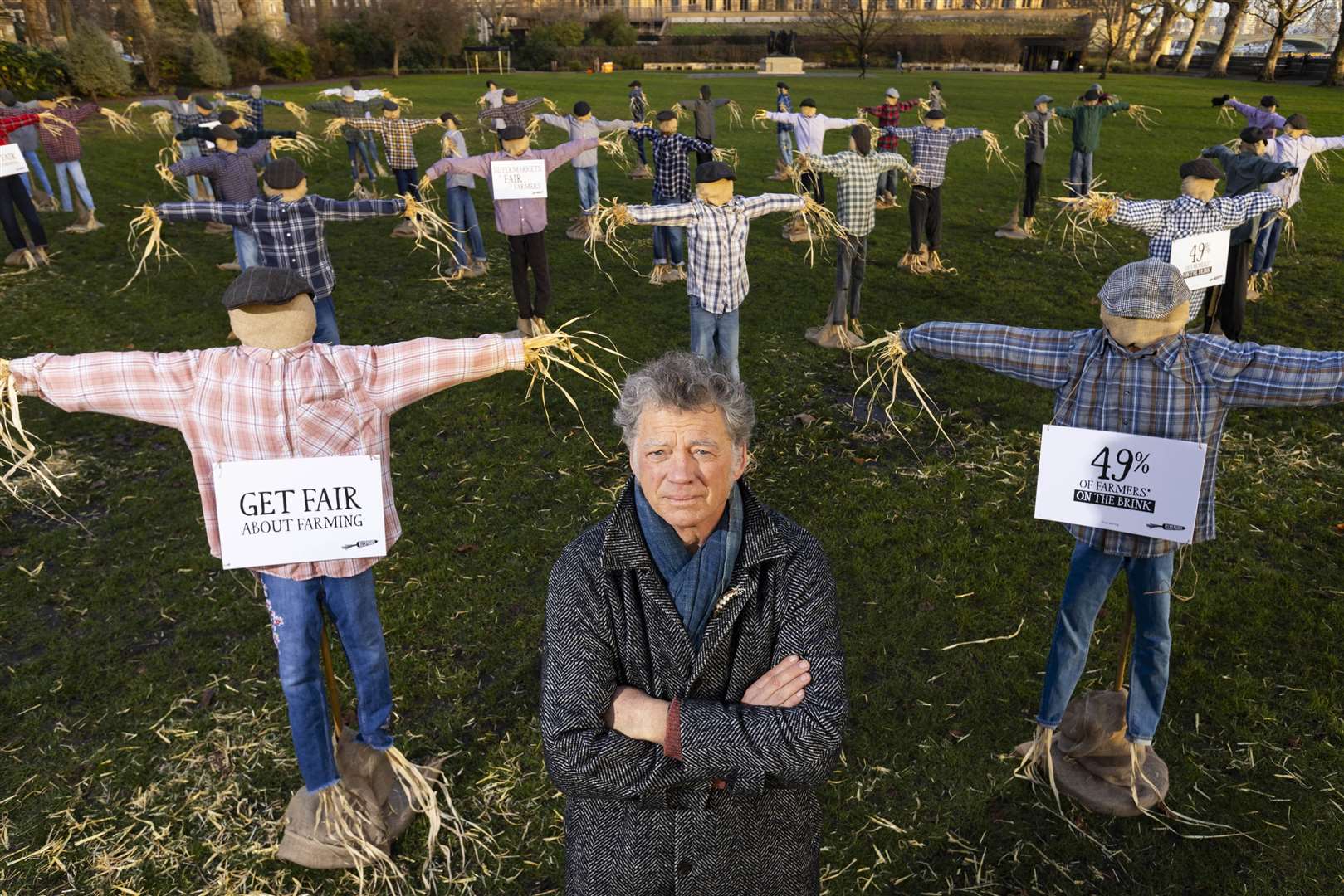 Riverford founder Guy Singh-Watson in front of 49 scarecrows outside Parliament (David Parry/PA)