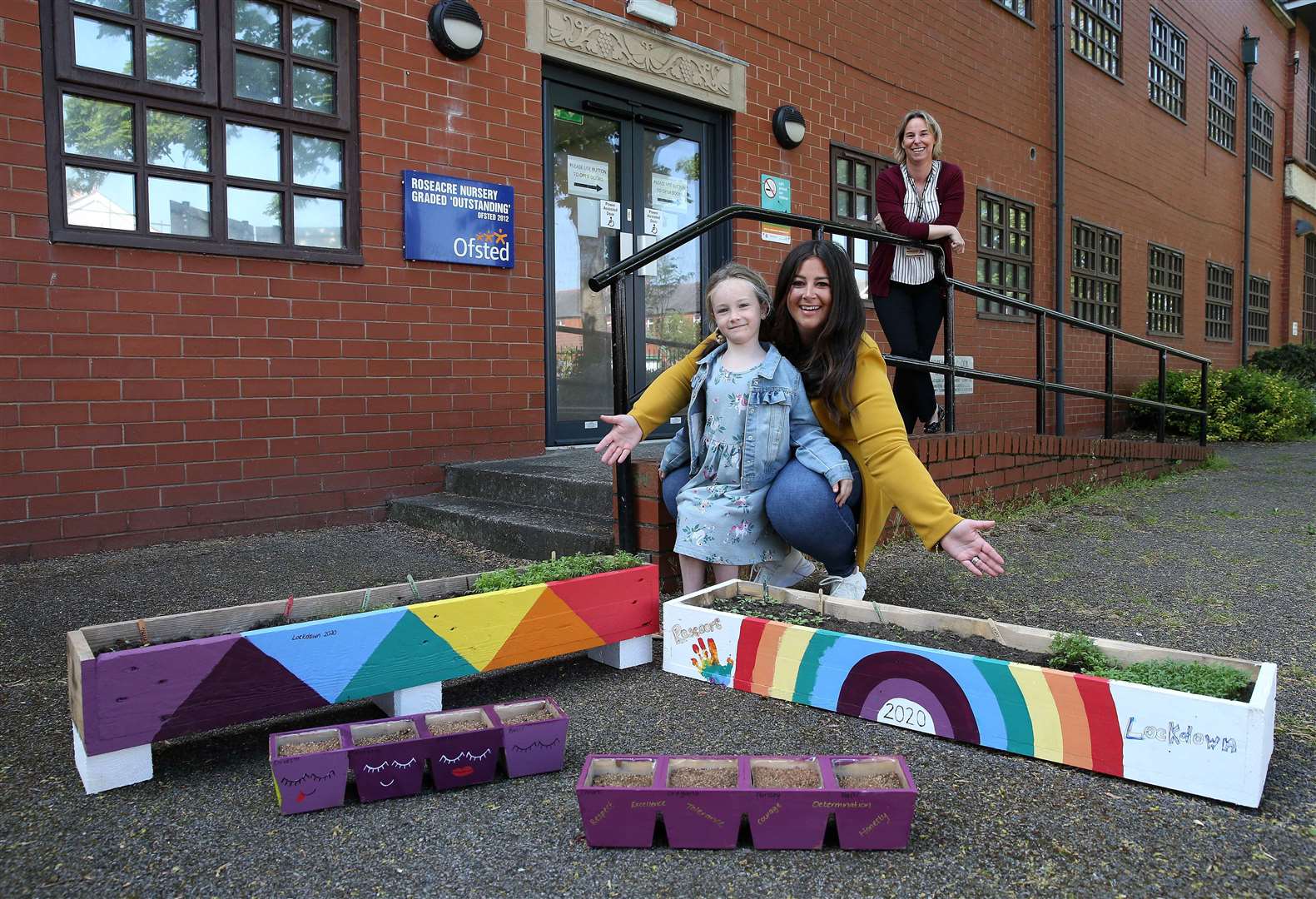 Natalie Cunliffe and her daughter Myah give some hand-made salad boxes to headteacher Samantha Boden at Roseacre Academy in Blackpool (Gareth Jones/PA)