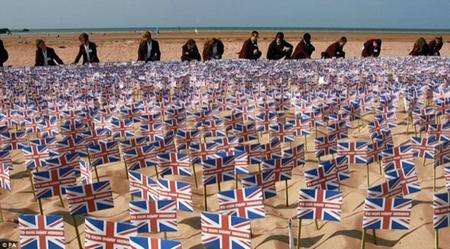 Students helping to place commemorative flags on the beach.