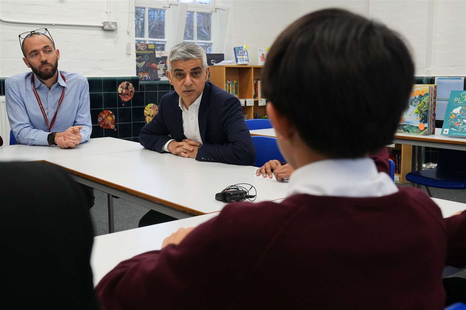 Mr Khan spoke to pupils during his visit to Avondale Park Primary School (Lucy North/PA)