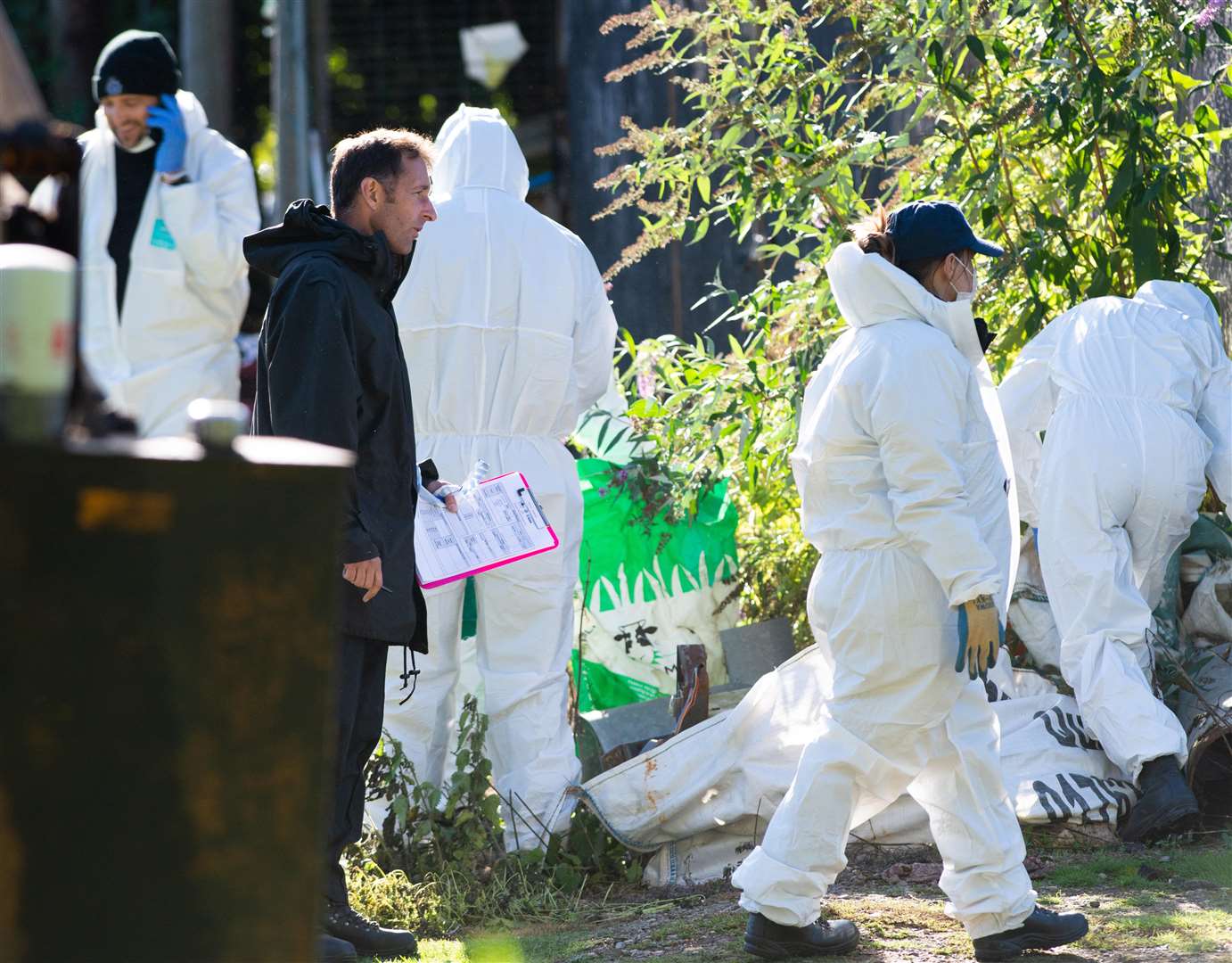 Police and forensics with gas masks at Mill Farm in Charlton, Herts