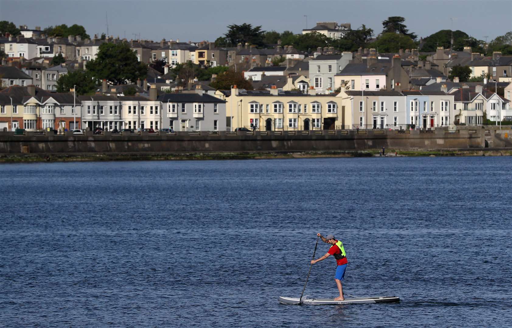 A man paddleboards in Dublin Bay as the sun shines (Brian Lawless/PA)