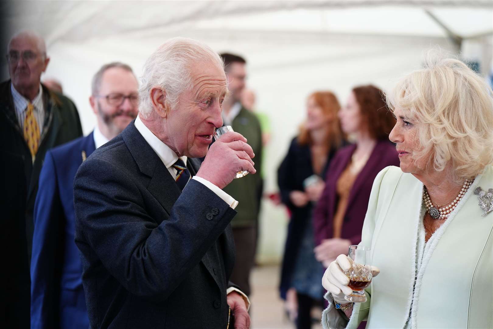 Charles and Camilla try a glass of Duncan Taylor whisky as they attend a celebration at Edinburgh Castle to mark the 900th anniversary of the City of Edinburgh (Jane Barlow/PA)