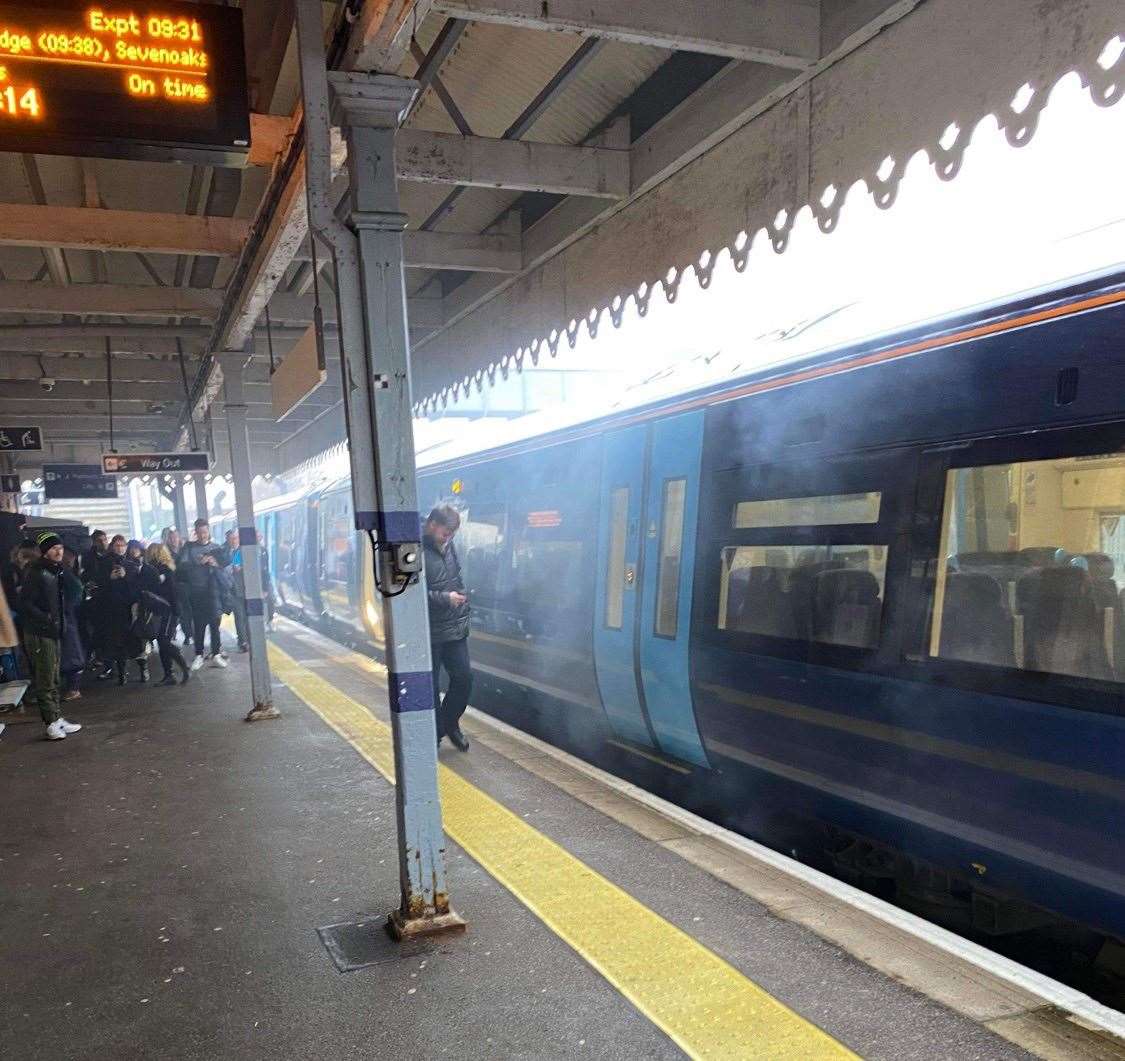 Smoke can be seen coming from a train at Paddock Wood railway station