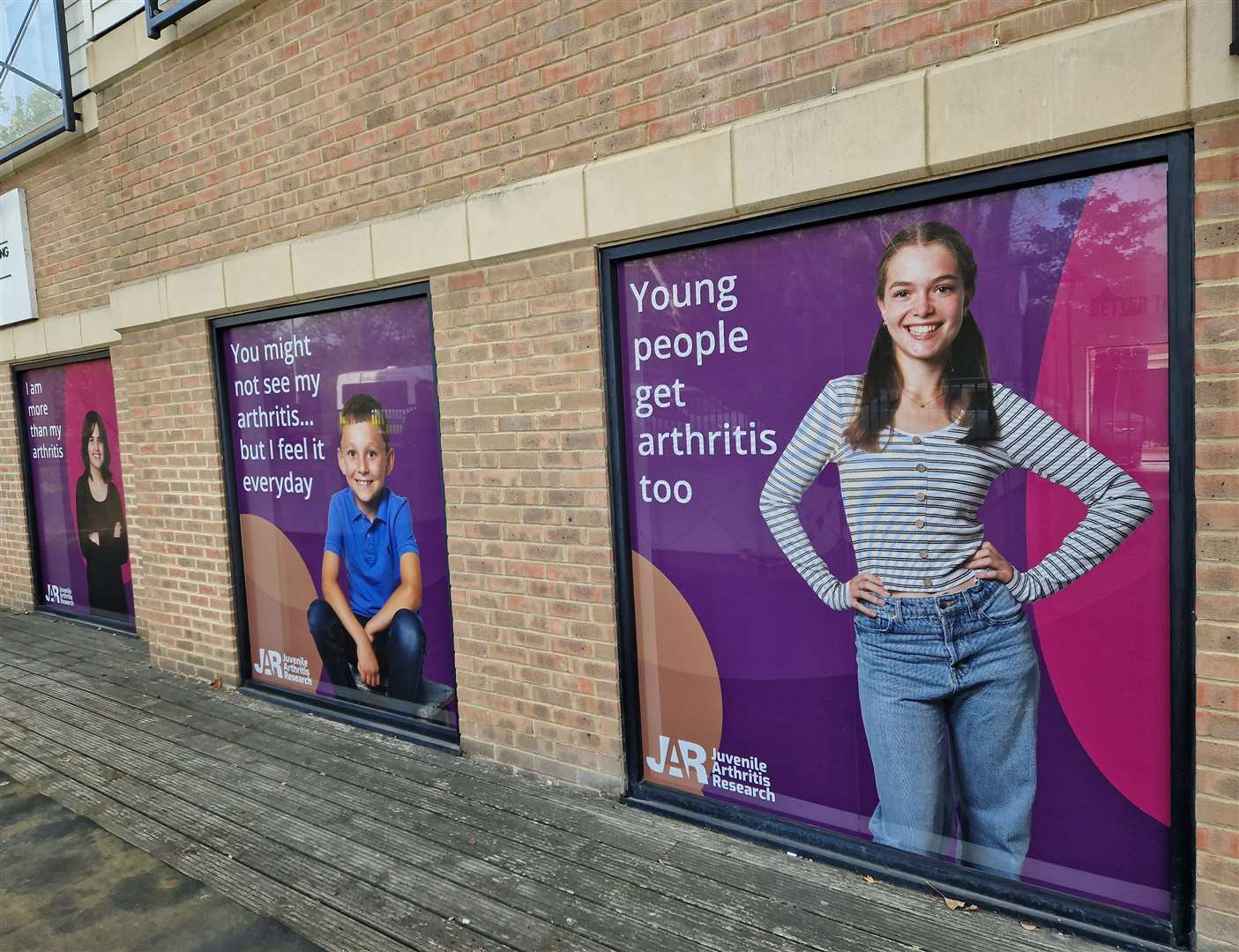 New window signage featuring local children, young people and families from the local area has been installed with thought-provoking imagery