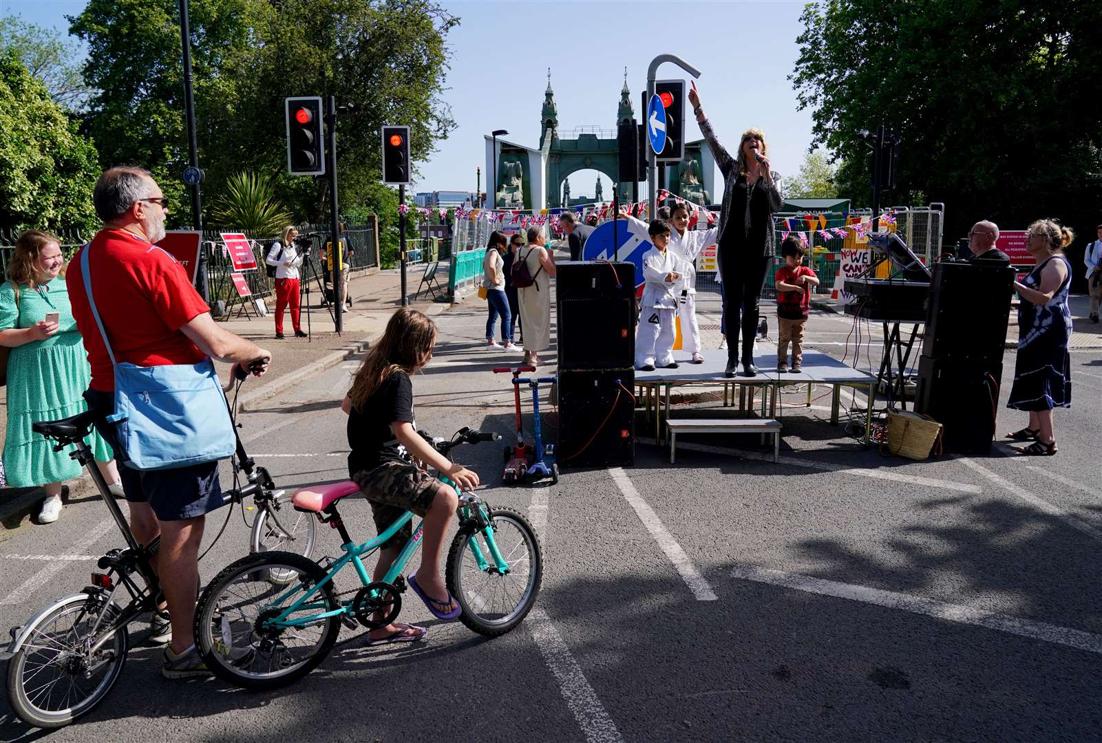 Local residents celebrate at the southern foot of Hammersmith Bridge in London as it reopens to pedestrians and cyclists (Jonathan Brady/PA)