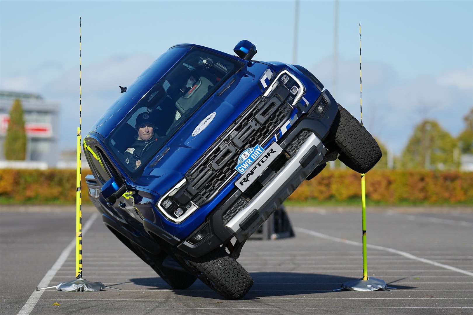 Paul Swift achieves the Guinness World Record for ‘The tightest gap driven through on two wheels in a pickup truck’ (88cm) (Guinness World Records Day 2023/PA)