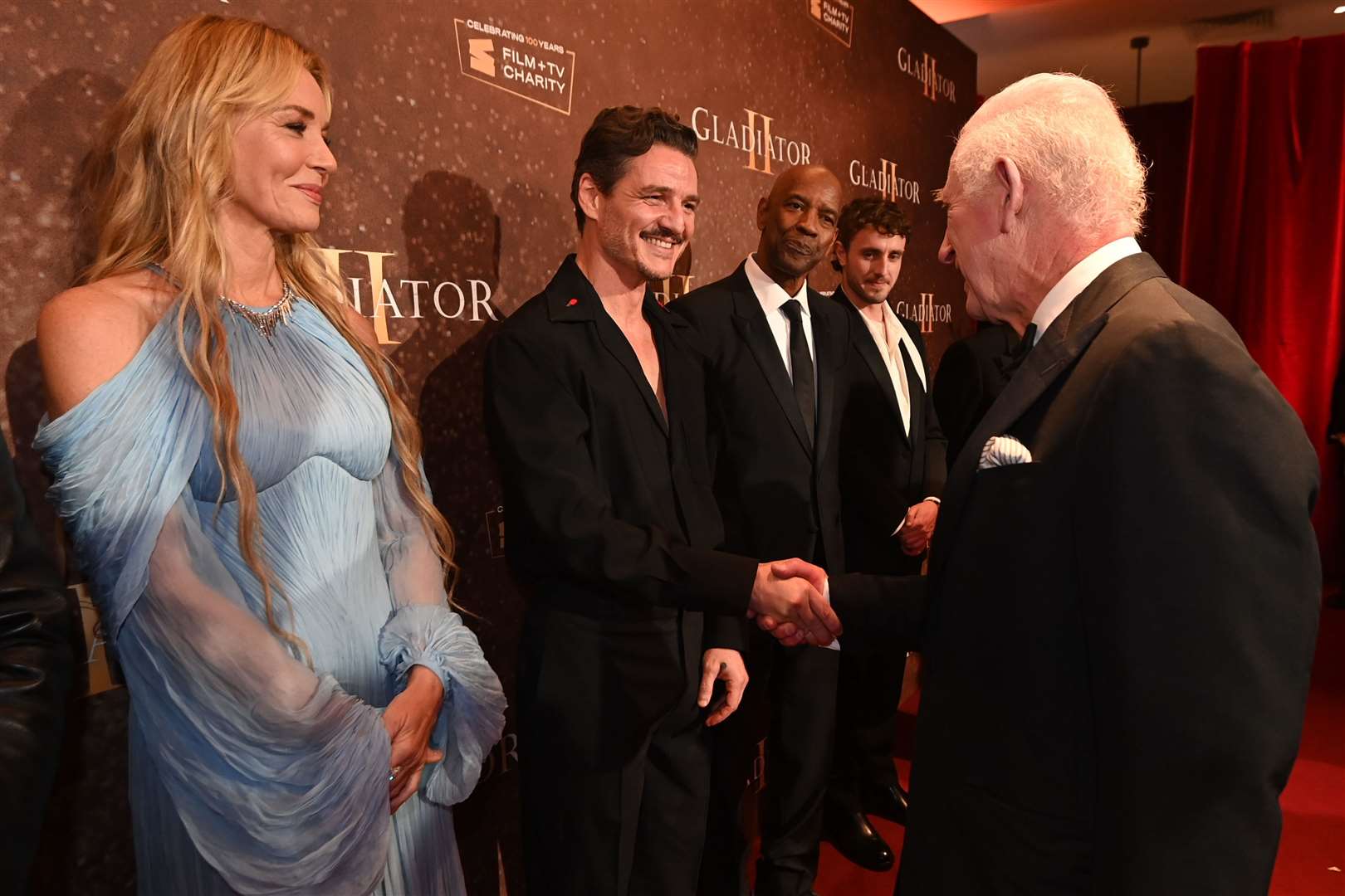 The King meets Pedro Pascal whilst attending the Royal Film Performance of Gladiator II on Wednesday evening (Eddie Mulholland/The Telegraph/PA)