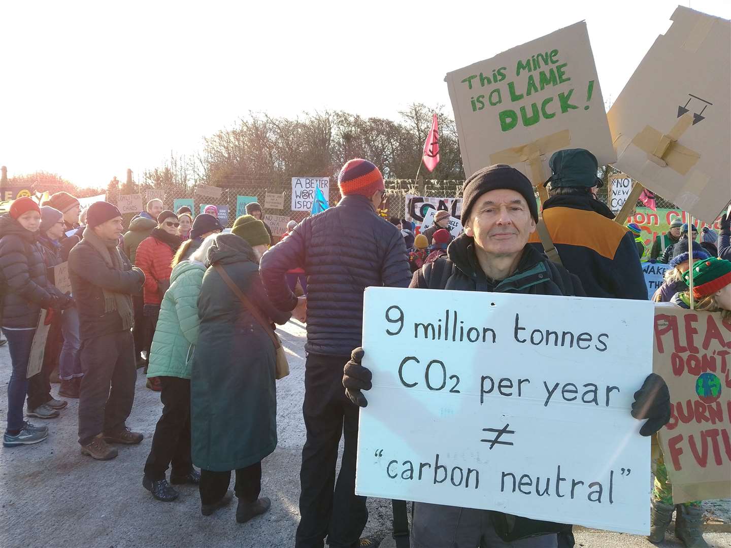 A protester holds up a placard at the protest against a new coal mine in Cumbria (Friends of the Earth)