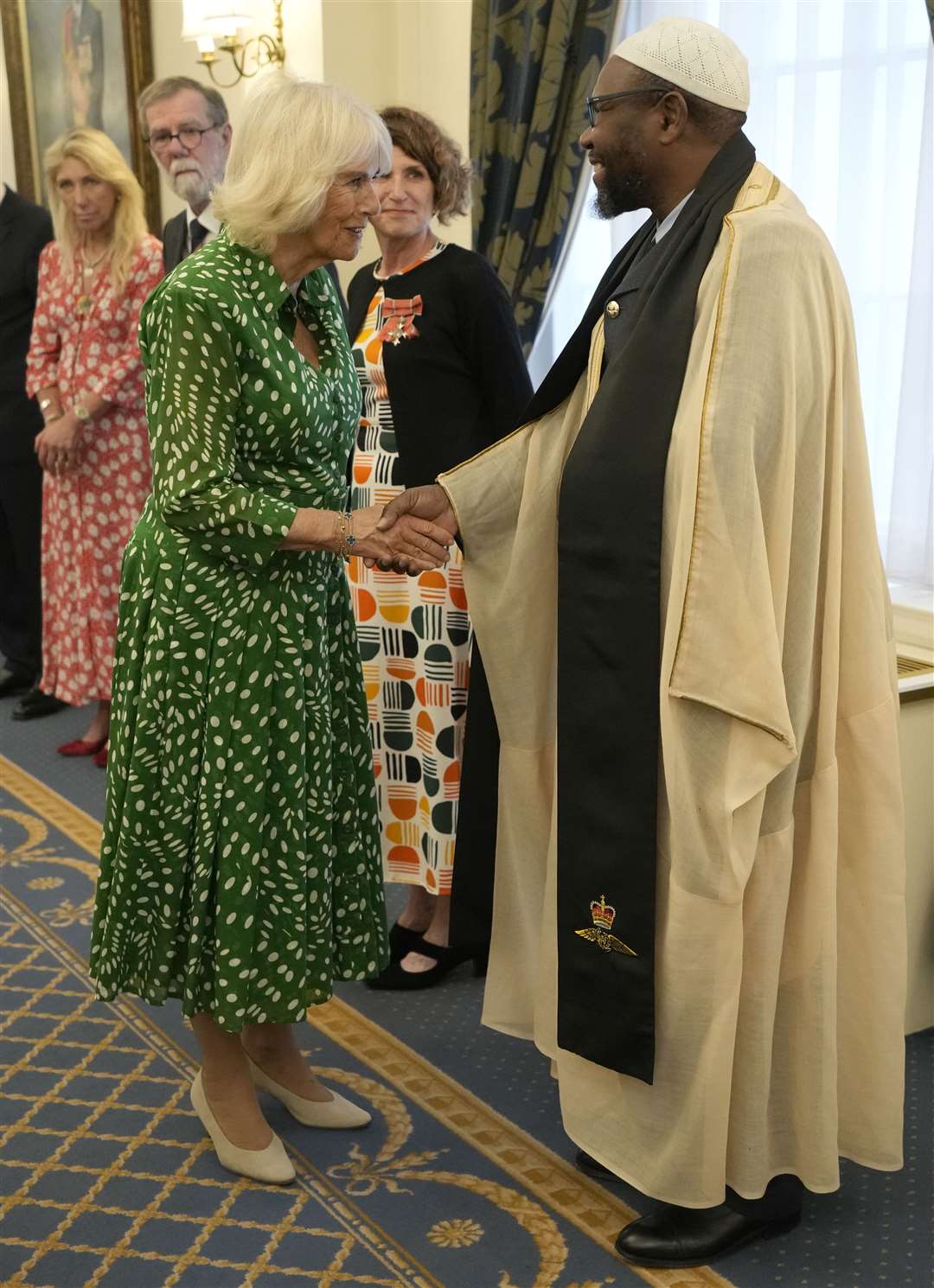 Queen Camilla meets Squadron Leader Imam Ali Omar at the Royal Air Force Club in Piccadilly, central London (Kirsty Wigglesworth/PA)