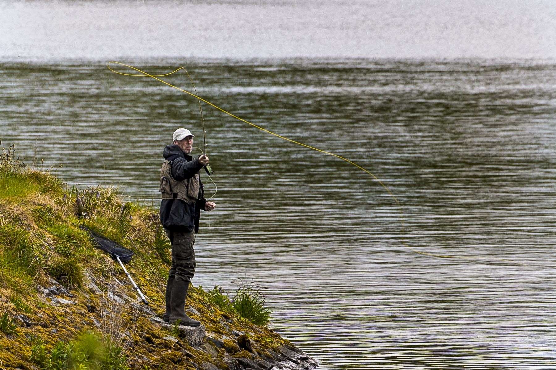 An angler fly fishing on the bank of Ballysallagh Lower Reservoir close to Bangor, Co Down (Liam McBurney/PA)