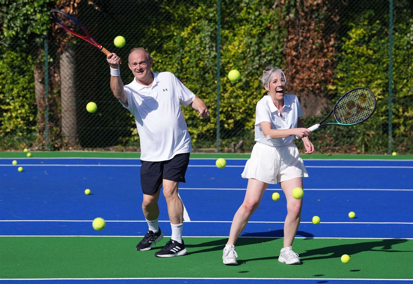 Liberal Democrat leader Sir Ed Davey playing tennis with his deputy Daisy Cooper at St Ann’s Tennis Courts in Brighton, before his keynote speech at the party’s autumn conference at the Brighton in September. (Gareth Fuller/PA)