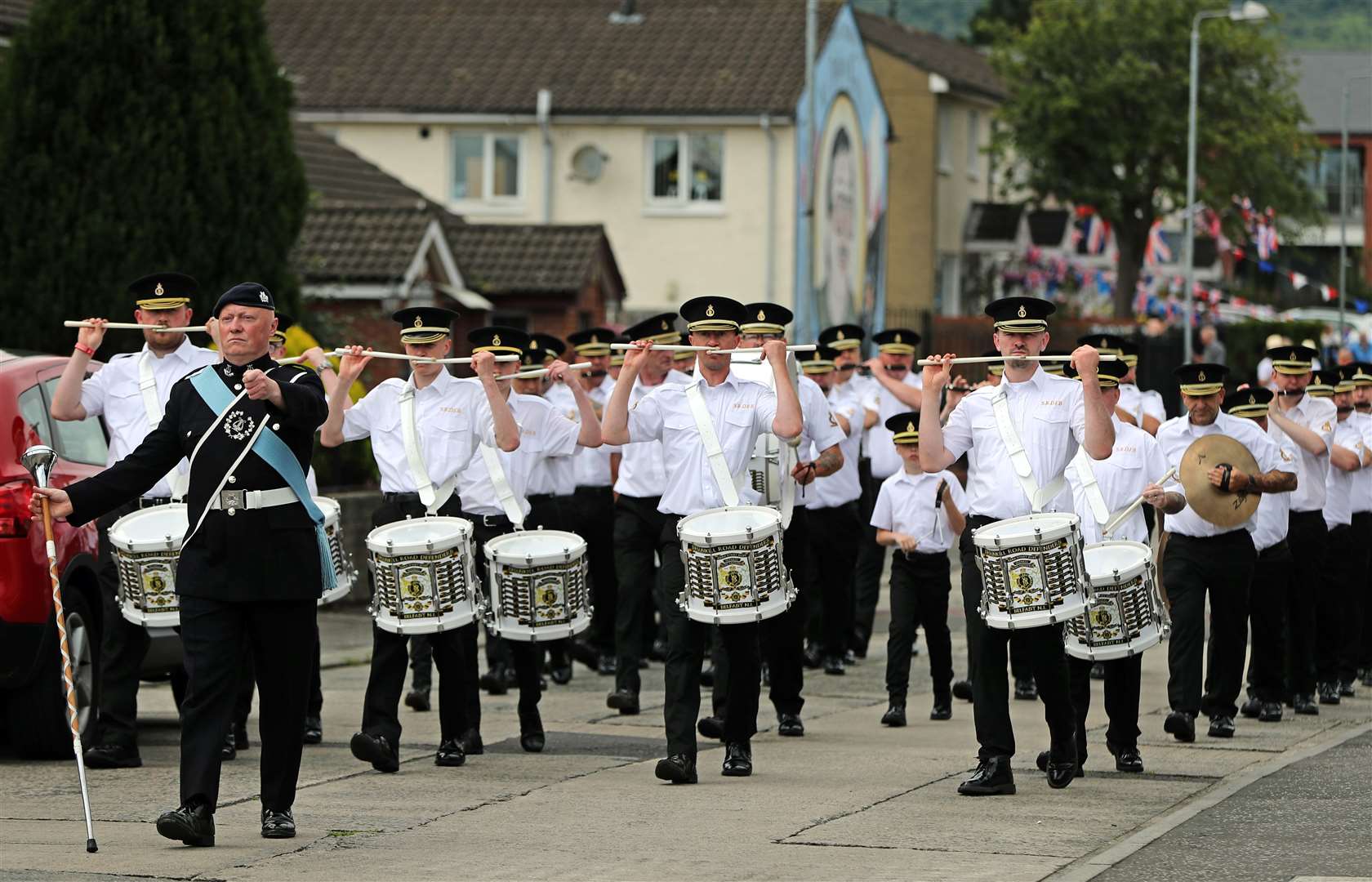 Members of the Shankill Road Defenders flute band march though the lower Shankill estate in Belfast (Niall Carson/PA)