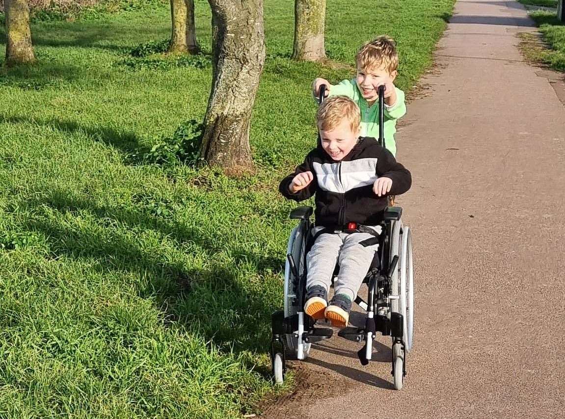 Freddie pushes Ralph, who suffers from mobility issues, in his wheelchair