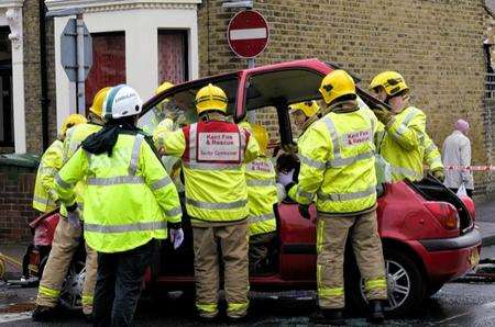 Firefighters and Ambulance staff work to free the woman from her car, which was involved in a collision with another vehicle at the junction of Winstanley Road and Alma Road