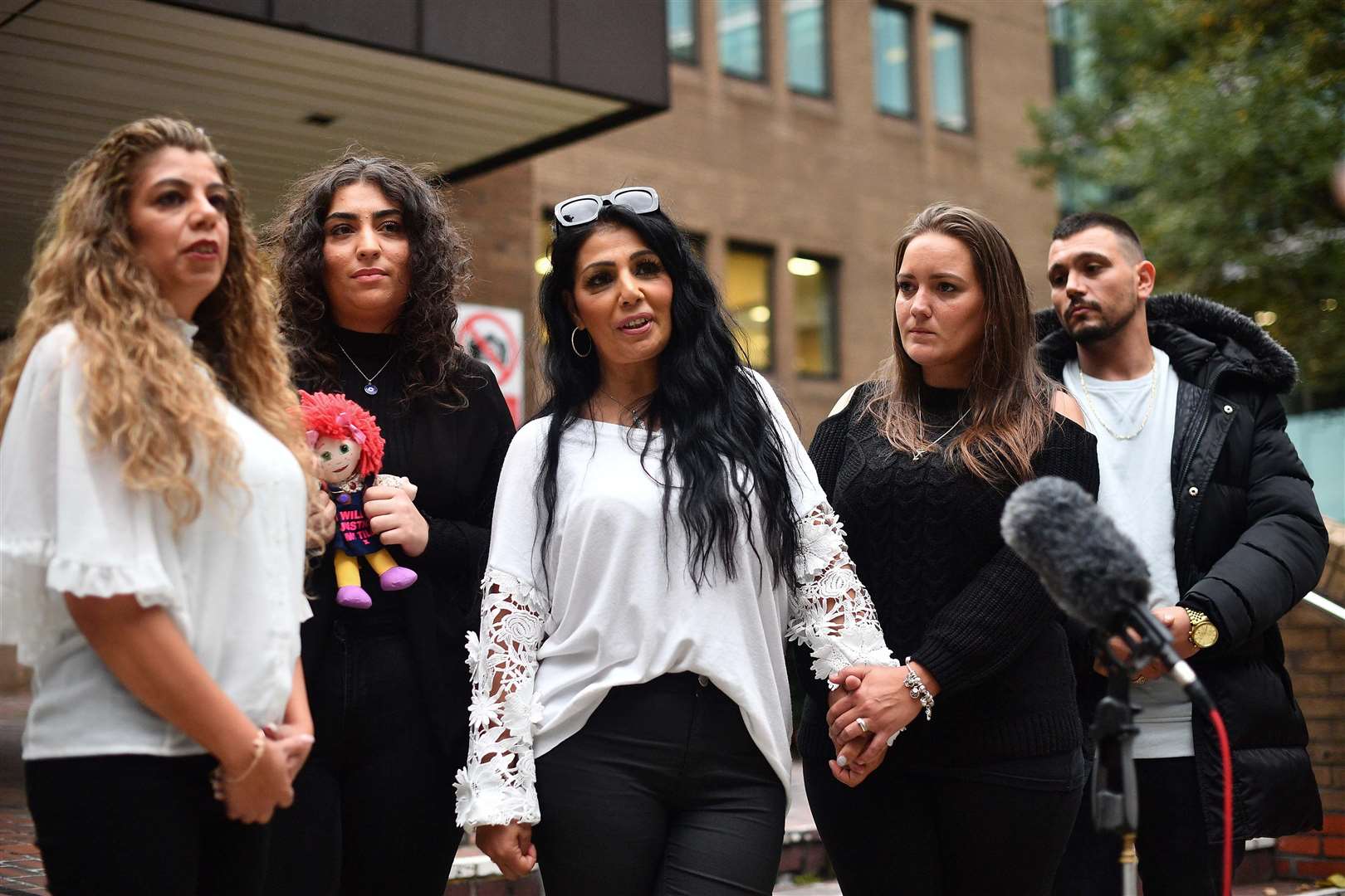 Ms Mustafa’s cousin Ayse Hussein, left, and sister Mel Mustafa, centre, outside Southwark Crown Court (Victoria Jones/PA)