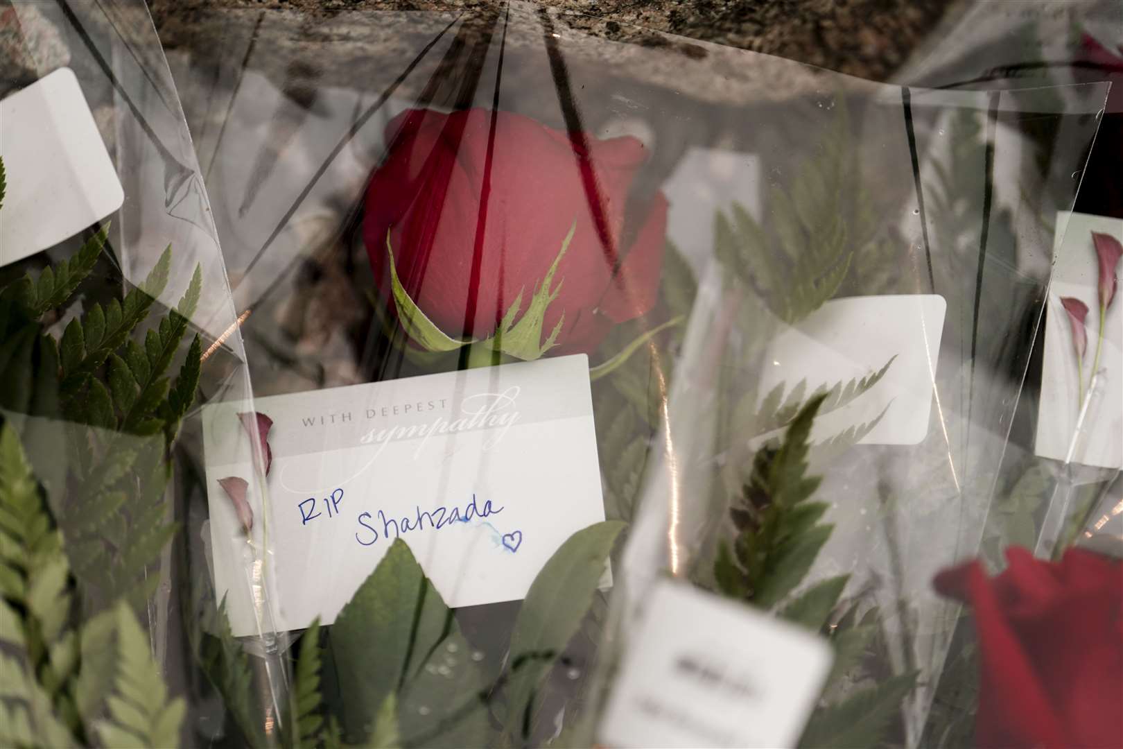 Flowers left at St John’s harbour on Friday (Jordan Pettitt/PA)