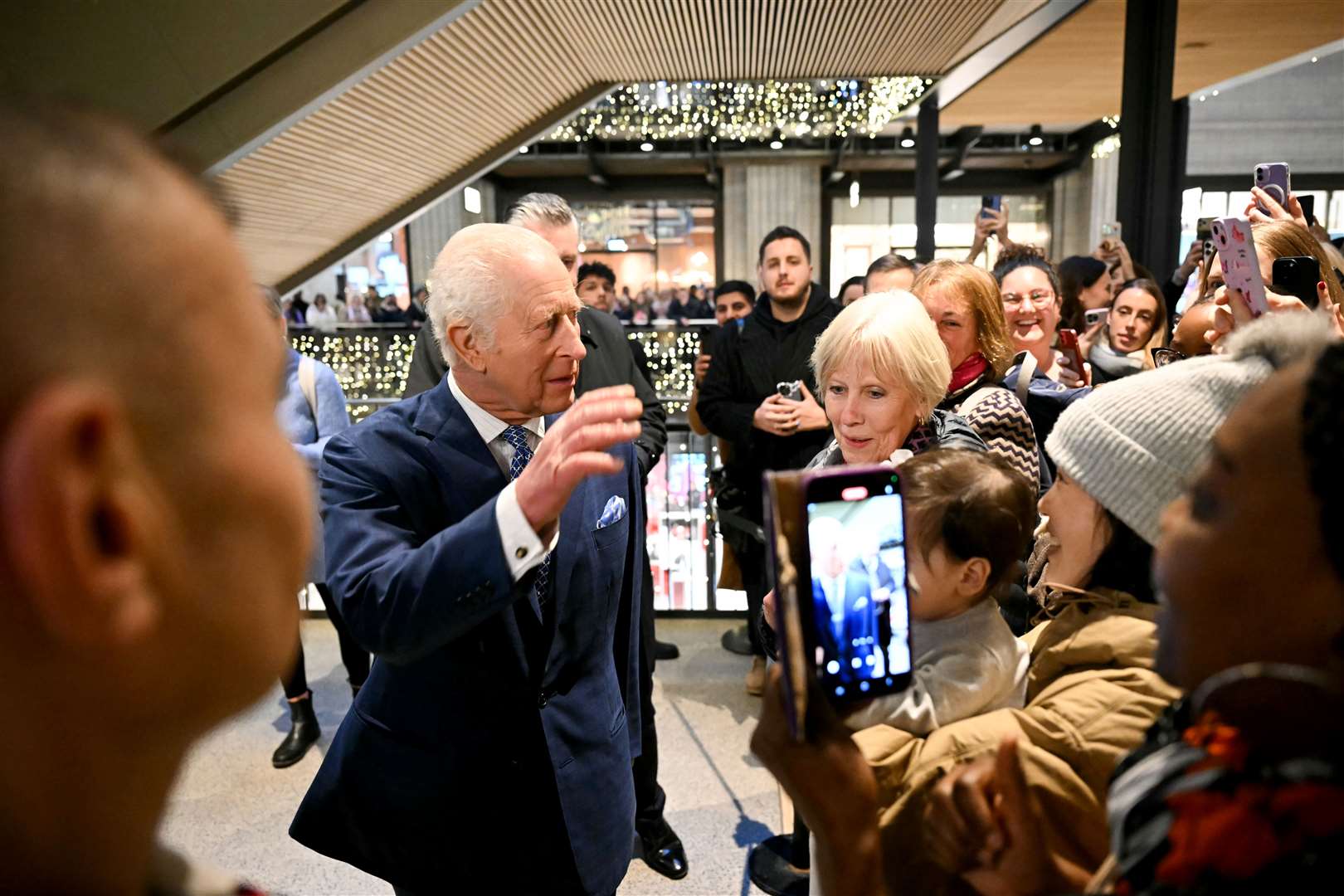 The King speaking with well-wishers during a visit to the Curated Makers Christmas Market inside Battersea Power Station (Justin Tallis/PA)