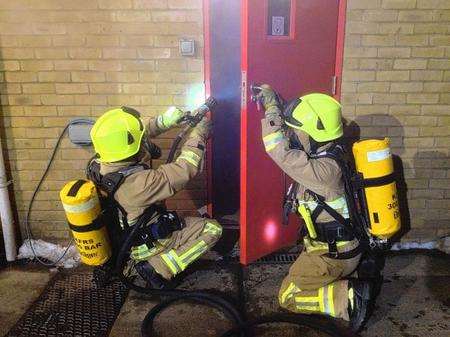 On-call firefighters preparing to enter the boat bay for a training drill.