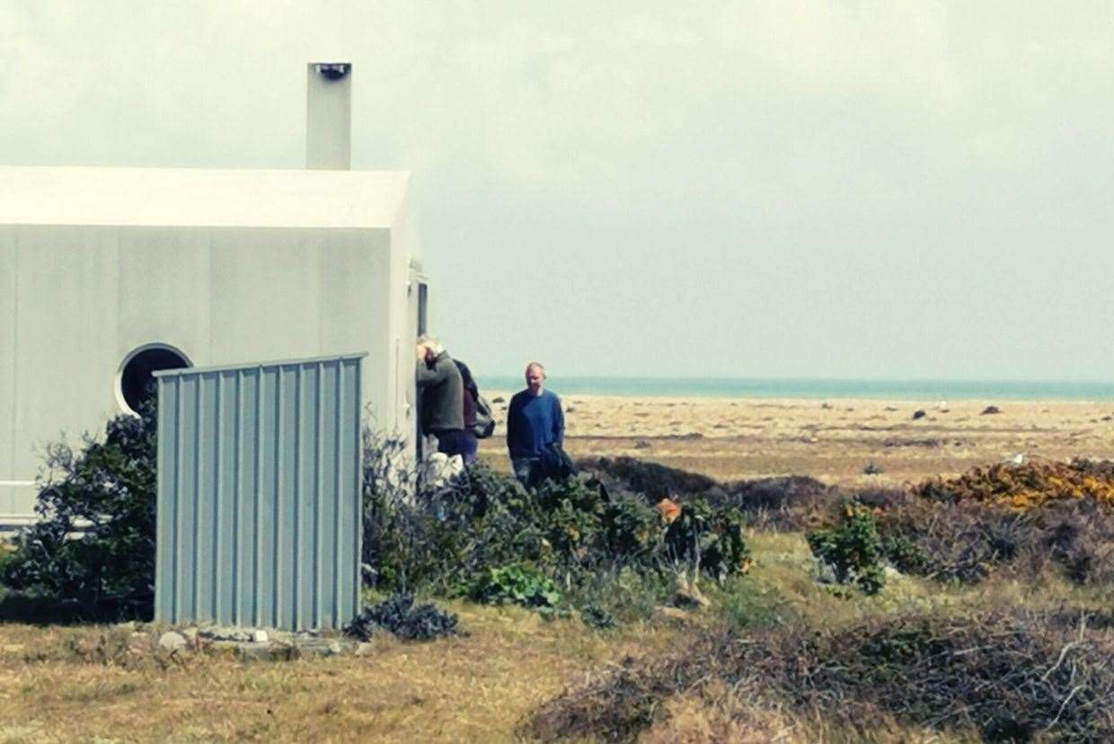 Visitors peering into the window of someone's home