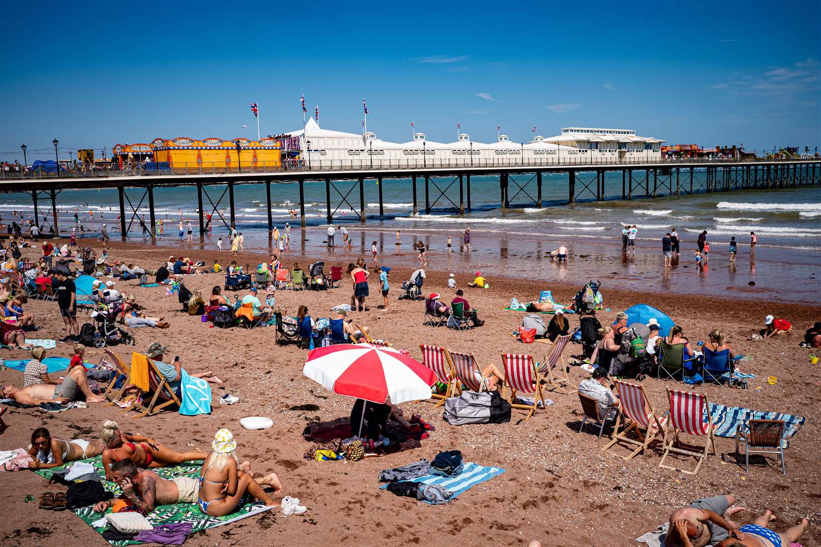 People enjoying the warm weather in Paignton, Torbay (Ben Birchall/PA)