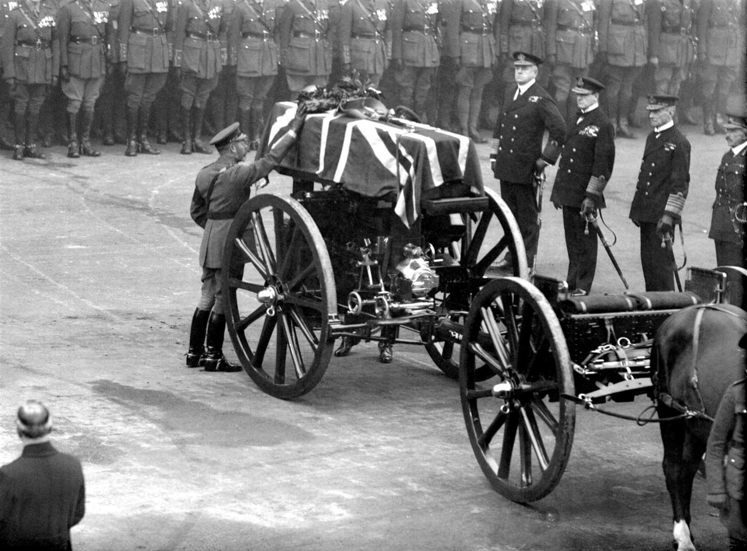 King George V pays his tribute as he placed a wreath on the coffin, mounted on a gun carriage, in Whitehall where the Cenotaph stands (PA)