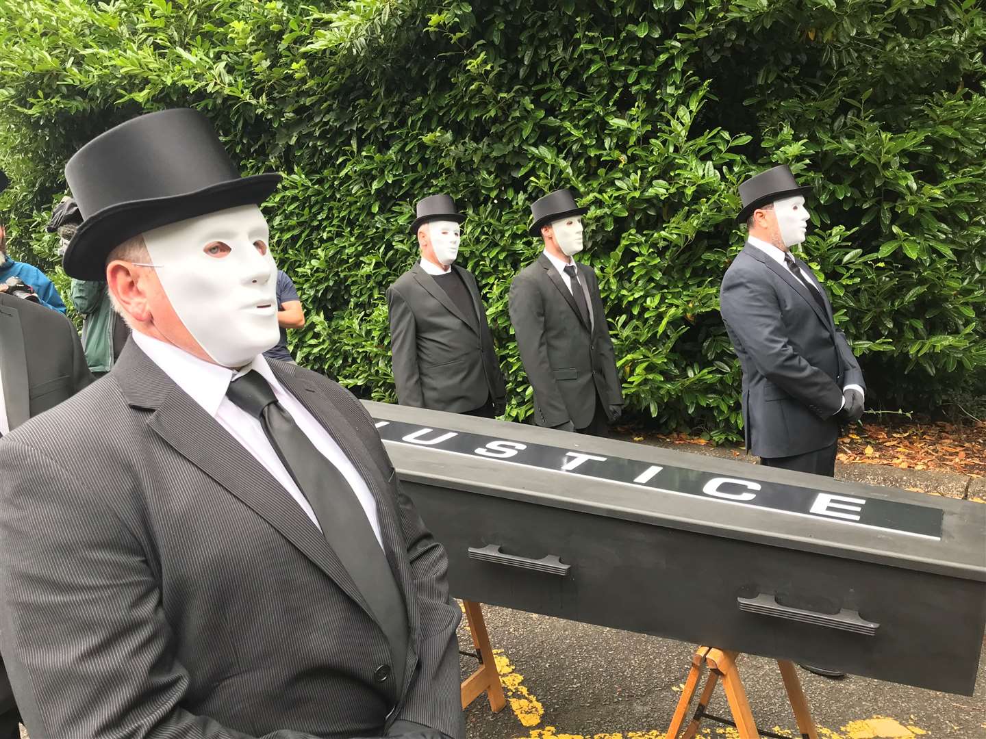 Protesters take the coffin to the gates of Stormont House (Jonathan McCambridge/PA)