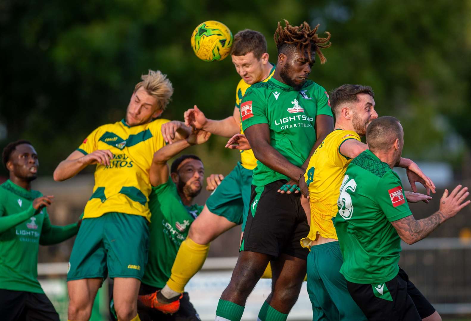 Ashford United midfielder Josh Wisson wins a header Picture: Ian Scammell