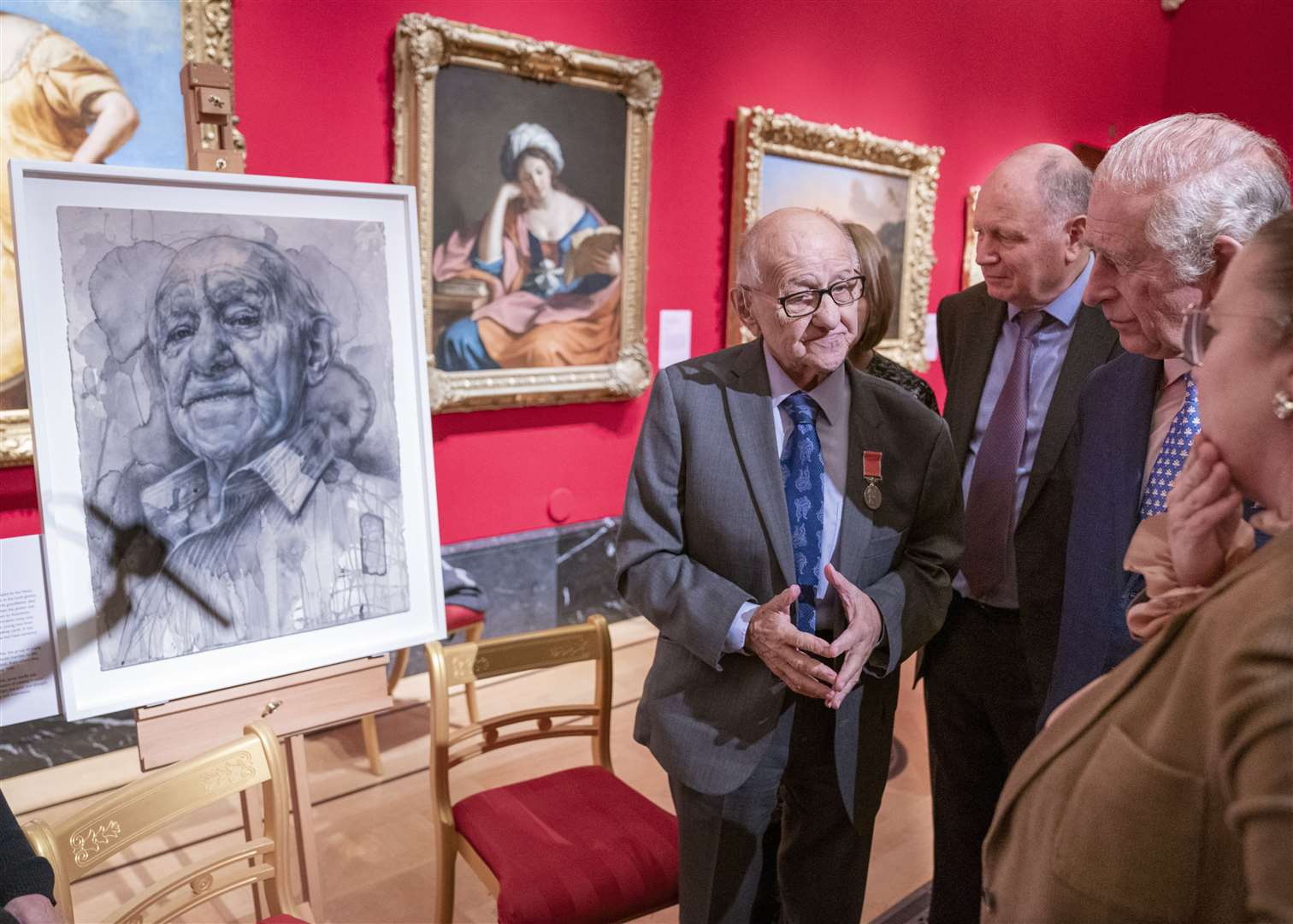 Charles studies the portrait of Holocaust survivor Zigi Shipper (left) as he speaks with him at exhibition at The Queen’s Gallery, Buckingham Palace (Arthur Edwards/The Sun)