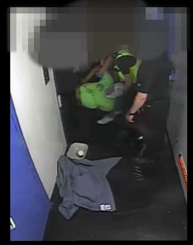 Andrew Hall being carried by police officers into a cell (West Yorkshire Police/PA)