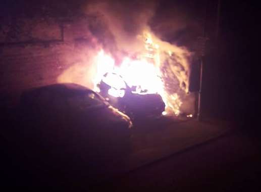 The car alight. Picture: Tom Baxter Tiffin